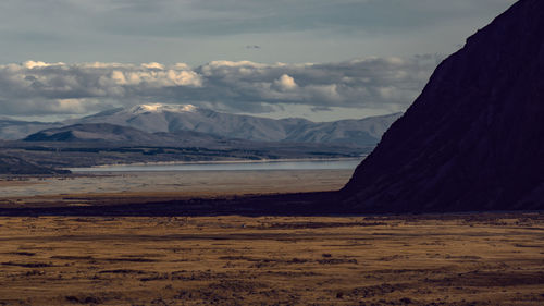 Scenic view of sea and mountains against sky