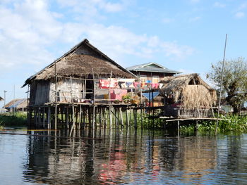 Stilt house by lake inle against sky in myanmar. 