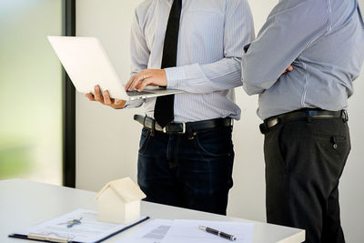 Midsection of businessmen working in office