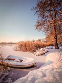 Snow covered landscape against sky during winter