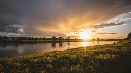 Scenic view of lake against sky during sunset