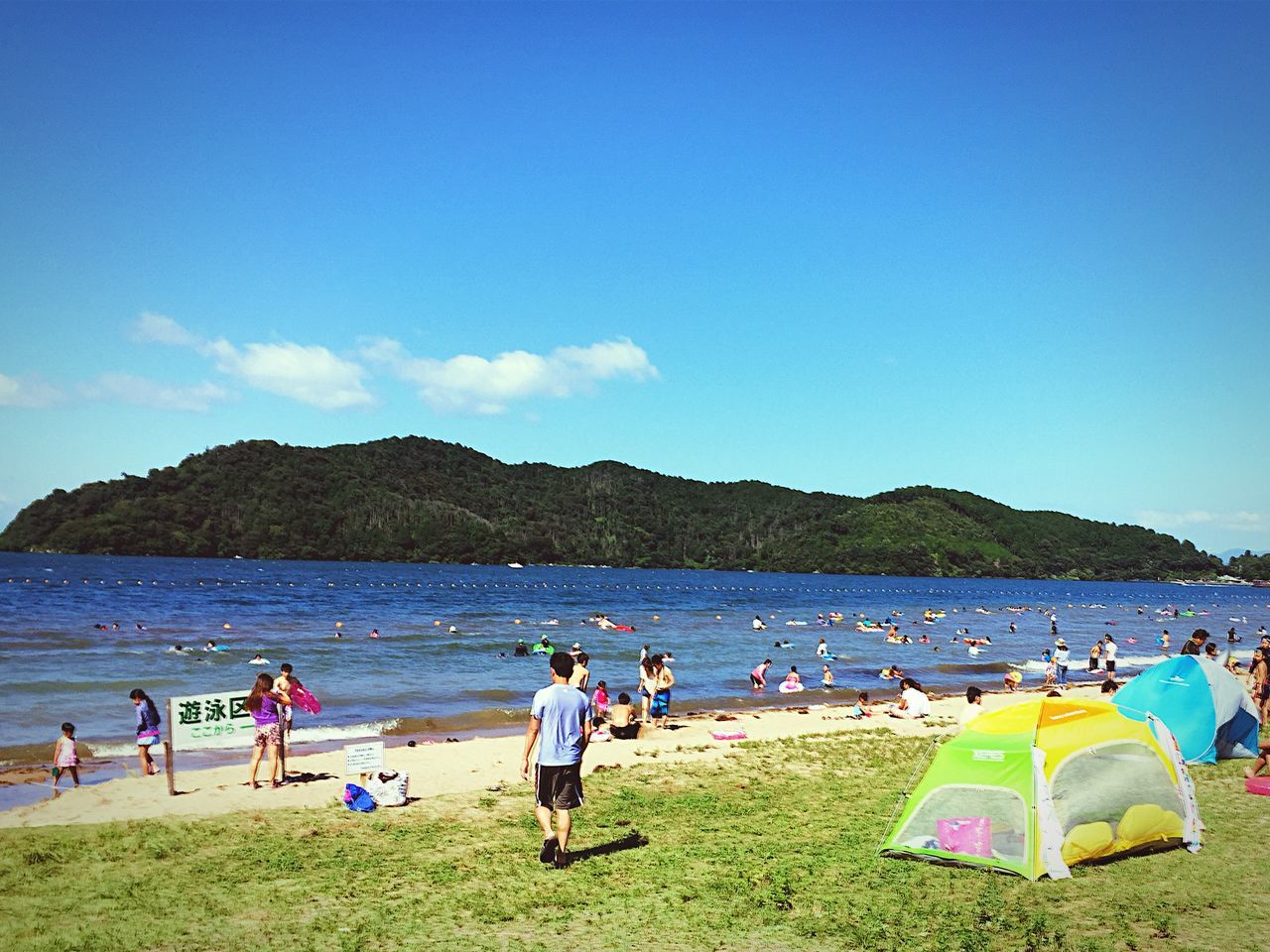 large group of people, water, leisure activity, beach, lifestyles, vacations, sea, person, relaxation, sky, enjoyment, shore, men, blue, scenics, weekend activities, mountain, mixed age range, nature