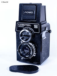 Close-up of camera against white background