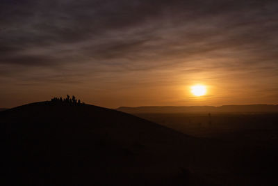 Scenic view of silhouette landscape against sky during sunset