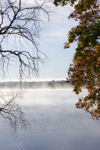 Scenic view of lake against sky during foggy weather