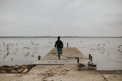 Man on beach against sky