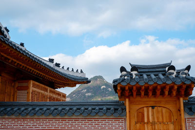 Low angle view of temple building against cloudy sky