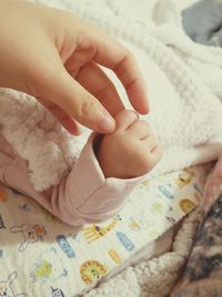 High angle view of baby lying on bed