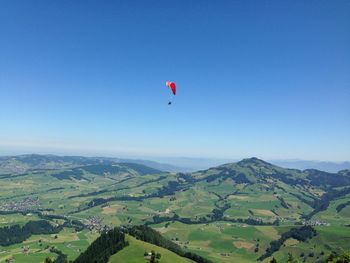 Hot air balloons flying over landscape