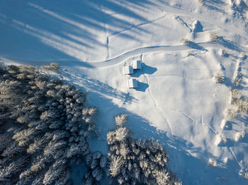 Aerial view of snow covered land and mountains