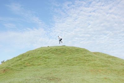 Man standing on land against sky