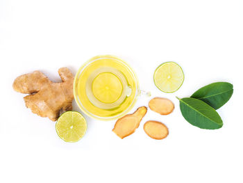 High angle view of lemon and leaves against white background