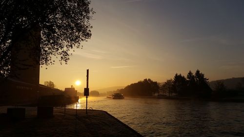 Scenic view of lake against sky at sunset