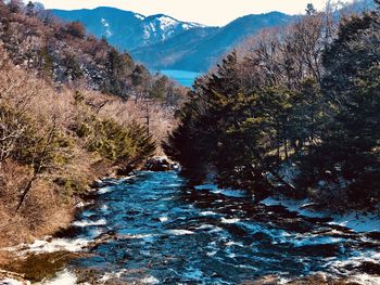 Scenic view of mountains against blue sky