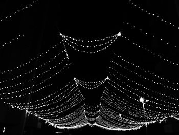 Low angle view of illuminated building against sky at night