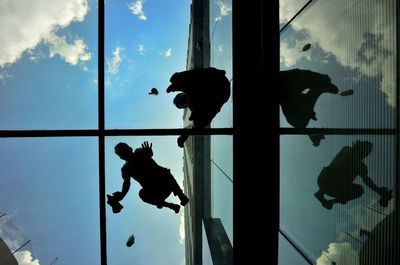 Directly below shot of window washers cleaning skylight