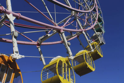 Low angle view of ferris wheel against clear sky