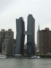 Modern buildings by city against sky