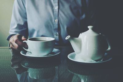 Close-up of man holding coffee cup