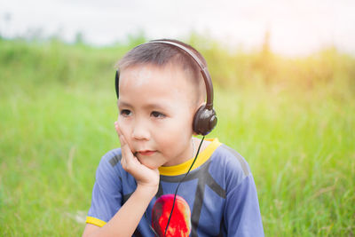 Portrait of cute boy on field