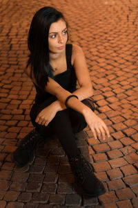 Portrait of a young woman sitting outdoors