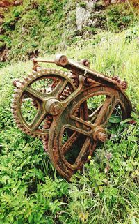 Old rusty wheel on field