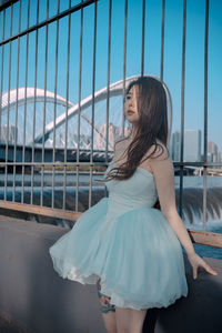 Portrait of young woman standing in boat