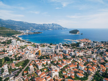 High angle view of townscape by sea against sky