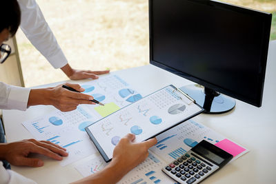 Close-up of business colleagues working in office