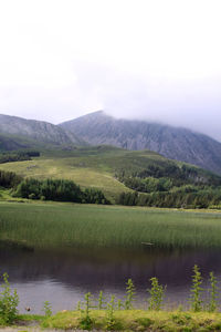 View of calm lake against mountain range