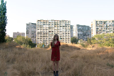 Portrait of a young woman standing on land