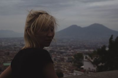 Woman standing against mountains