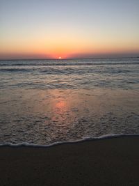 Scenic view of sea against clear sky during sunset