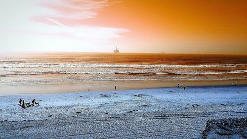 Scenic view of beach against sky during sunset