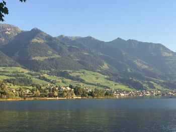 Scenic view of lake and mountains against clear sky