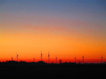 Scenic view of silhouette field against romantic sky at sunset