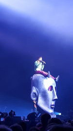 Low angle view of statue against blue sky