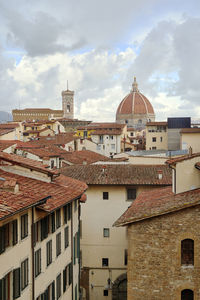 Buildings in town against sky