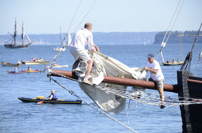 Boats sailing in sea against sky