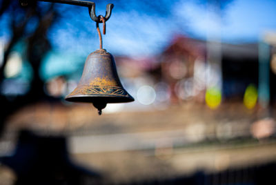 Close-up of illuminated lamp hanging on metal