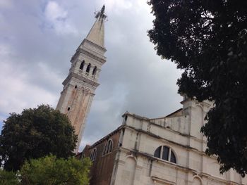 Low angle view of building against cloudy sky