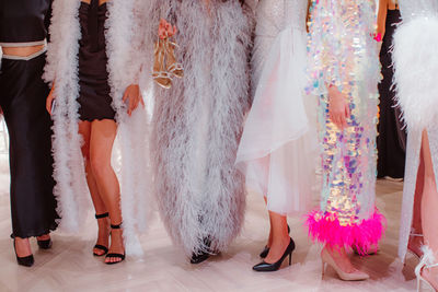 Fashion models on backstage dressed in a long haute couture boudoir dresses outfits and high heels