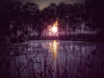 Scenic view of lake against sky at sunset