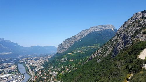 Scenic view of mountains against clear blue sky