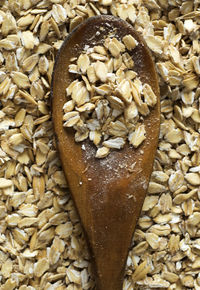 High angle view of wooden spoon on wheat grain