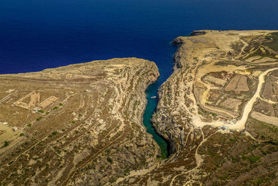 High angle view of land and sea against sky