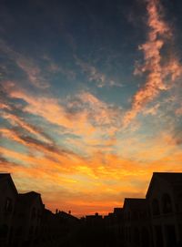 Low angle view of building against sky at sunset