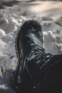 High angle view of black shoes on snow