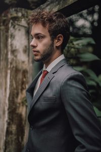 Portrait of young man standing at home