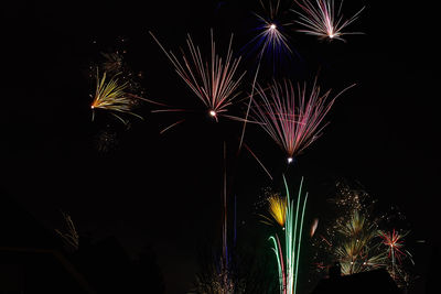 Low angle view of firework display at night